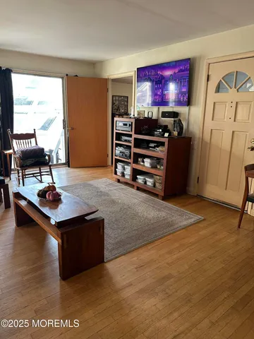 a living room with furniture a rug and a flat screen tv