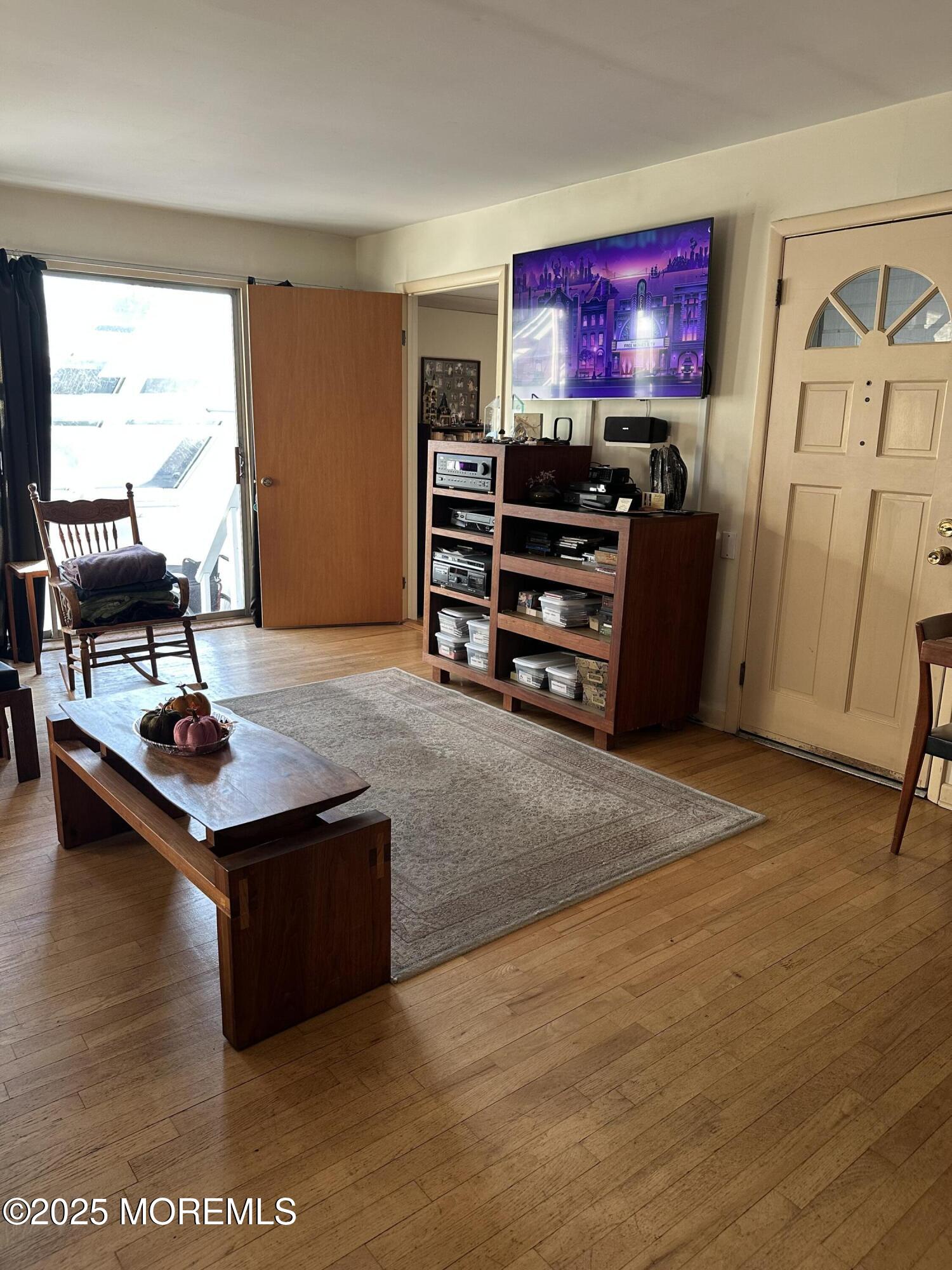 15 Georgia Tavern Road Farmingdale, NJ 07727 - Photo 3 of 17 a living room with furniture a rug and a flat screen tv