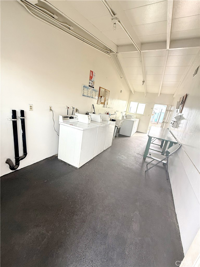 185 North Eucalyptus Avenue, Unit 53 Rialto, CA 92376 - Photo 14 of 38 a living room with couches and kitchen view with wooden floor