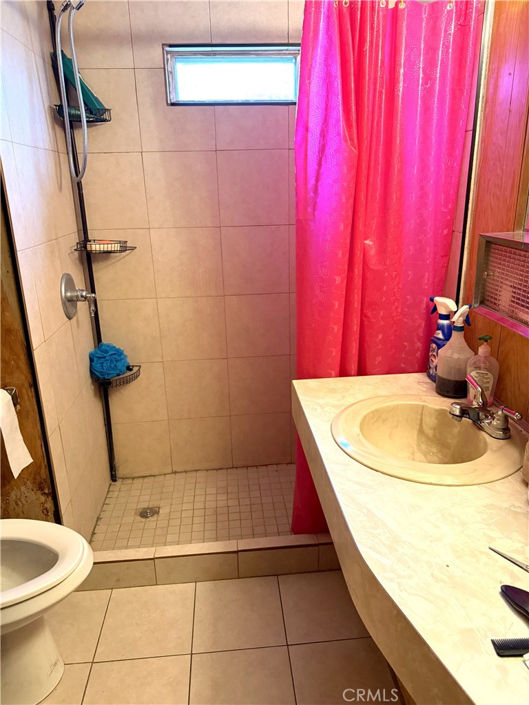 185 North Eucalyptus Avenue, Unit 53 Rialto, CA 92376 - Photo 23 of 38 a bathroom with a sink a toilet and a mirror