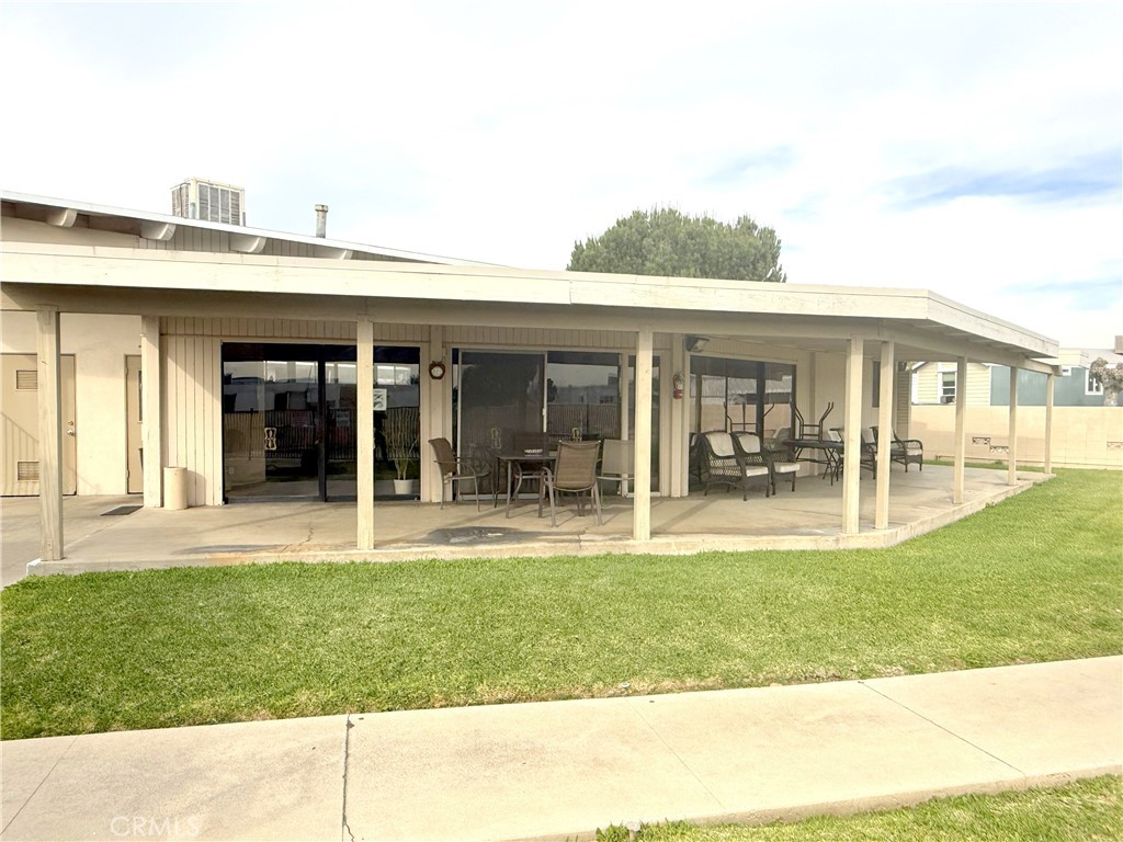 185 North Eucalyptus Avenue, Unit 53 Rialto, CA 92376 - Photo 28 of 38 a view of a patio with table and chairs and potted plants