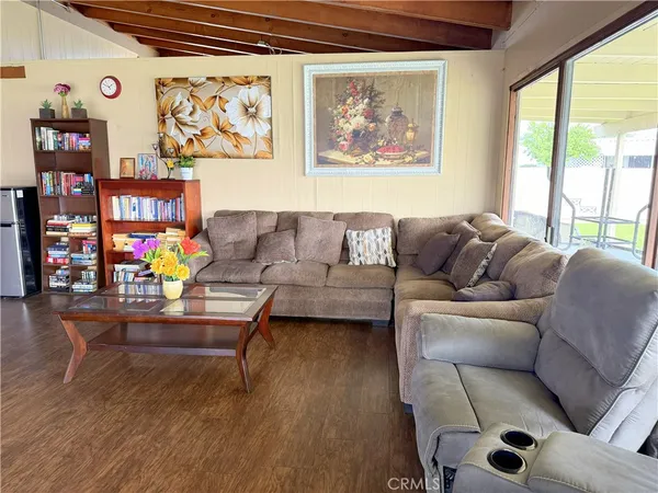 a living room with furniture and paintings on the wall