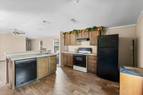a kitchen with a refrigerator stove and sink
