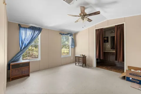 a view of room with window and ceiling fan