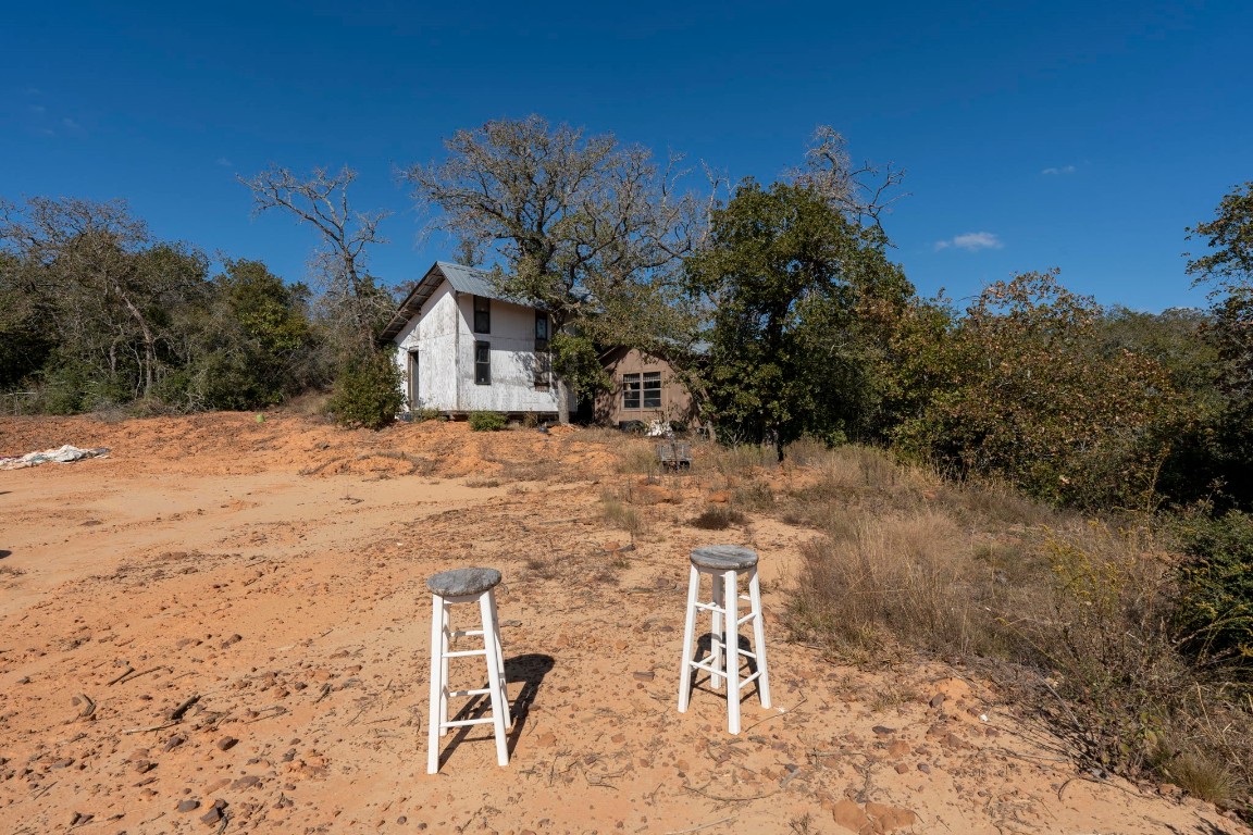3115 Chuckwagon Road Luling, TX 78648 - Photo 4 of 25 a backyard of a house with lots of green space