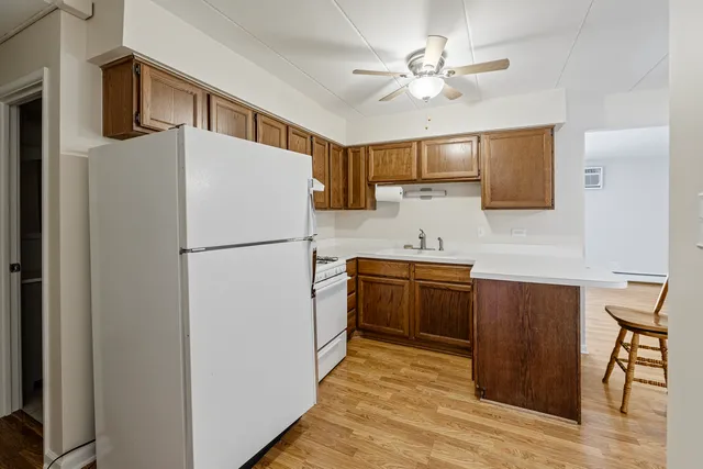 a kitchen with granite countertop a refrigerator a sink and dishwasher