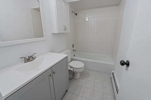 a kitchen with a refrigerator a stove top oven a sink and dishwasher with wooden floor