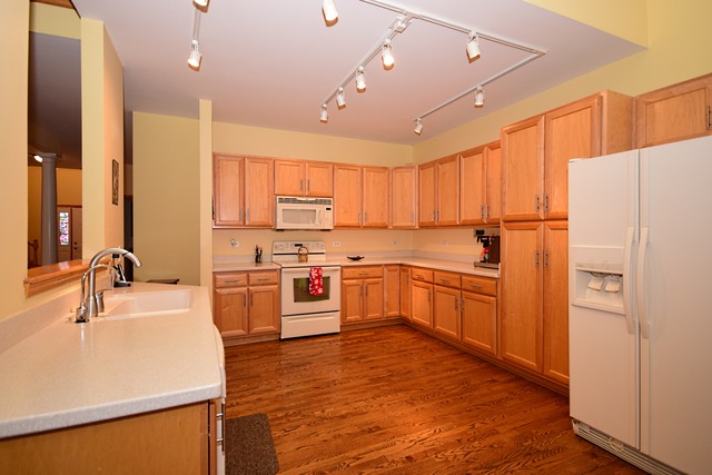 1859 Wagner Road Batavia, IL 60510 - Photo 6 of 25 a kitchen with a refrigerator a sink and cabinets