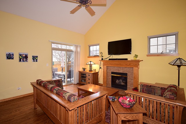 1859 Wagner Road Batavia, IL 60510 - Photo 9 of 25 a living room with furniture a flat screen tv and a fireplace