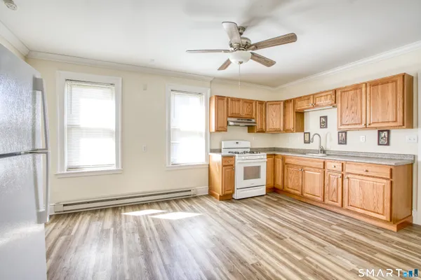 a kitchen with granite countertop a window cabinets and stainless steel appliances