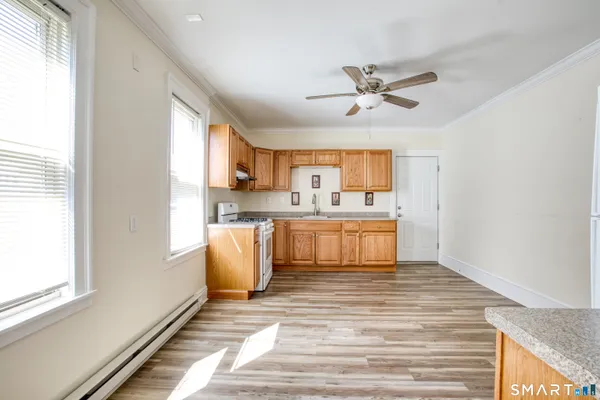 a kitchen with stainless steel appliances granite countertop a sink a stove and cabinets