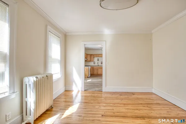 a view of a room with wooden floor and window