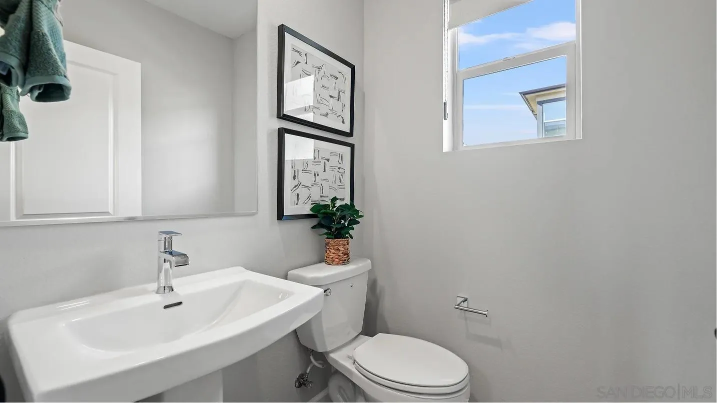 322 Honeysuckle Way Oceanside, CA 92057 - Photo 10 of 12 a bathroom with a sink mirror and toilet