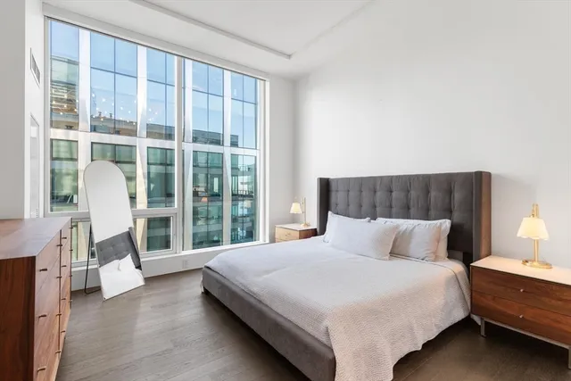 a bedroom with a large bed and a large window