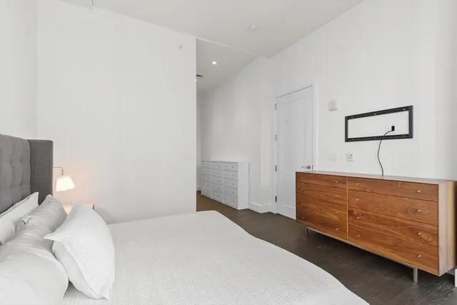 a bedroom with a bed and cabinet