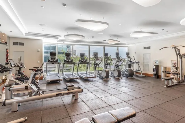 a room with gym equipment and large mirror