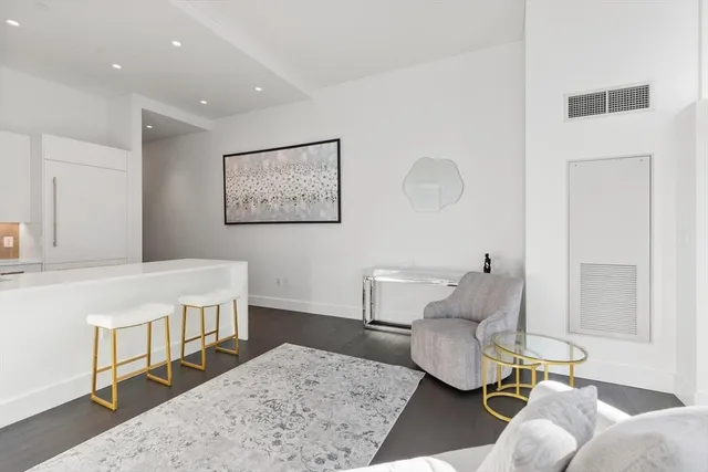 a living room with a couch and a rug