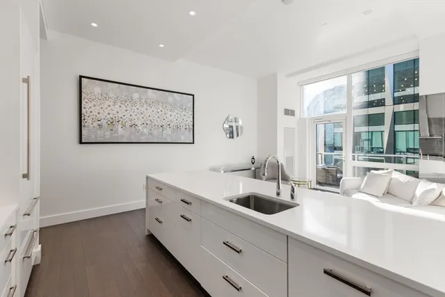 a kitchen with stainless steel appliances a sink and a large window