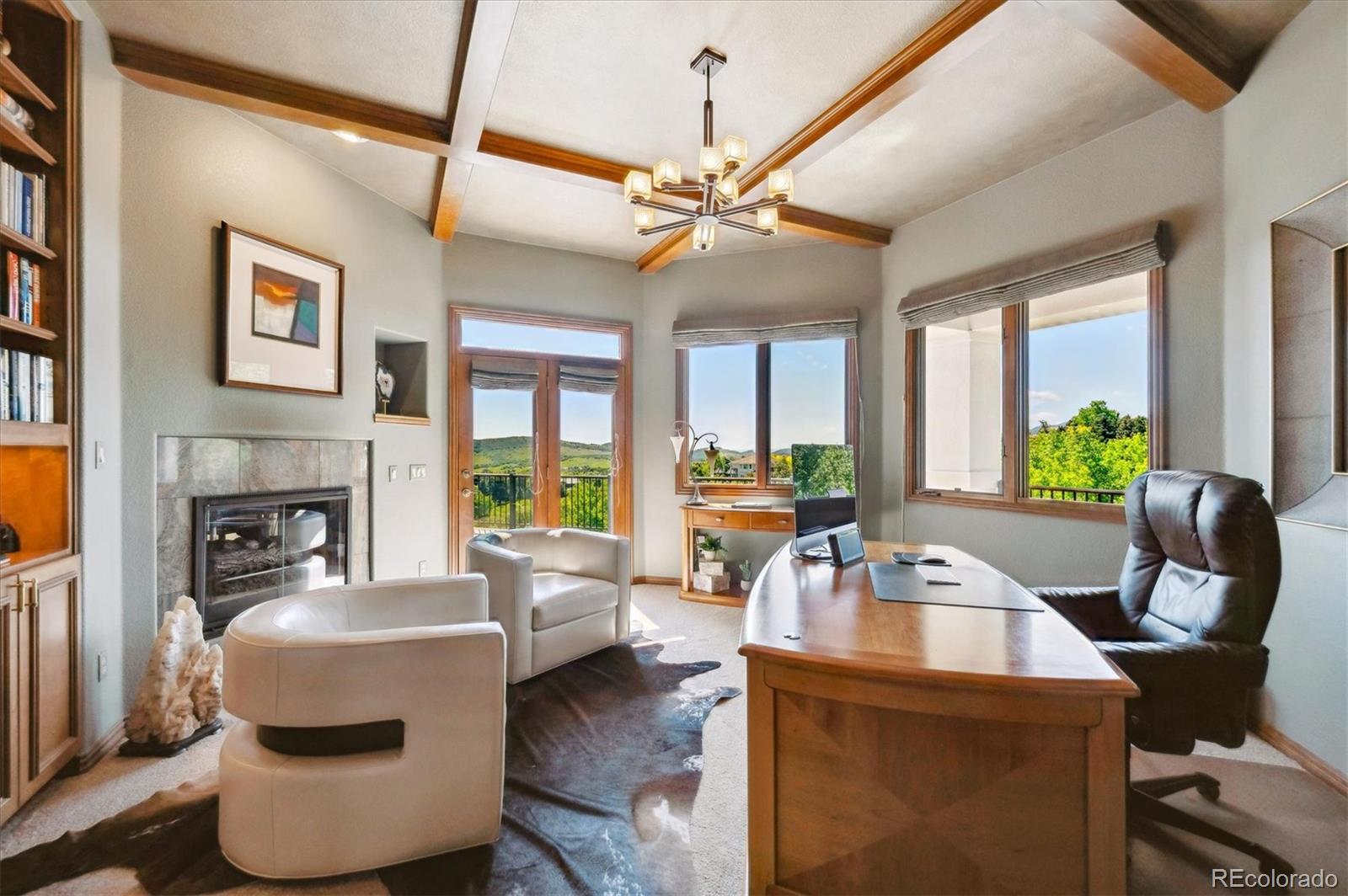 16134 Sandstone Drive Morrison, CO 80465 - Photo 11 of 30 a work room with furniture and a floor to ceiling window