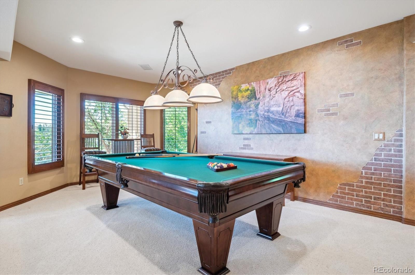 16134 Sandstone Drive Morrison, CO 80465 - Photo 19 of 30 a room with pool table and windows