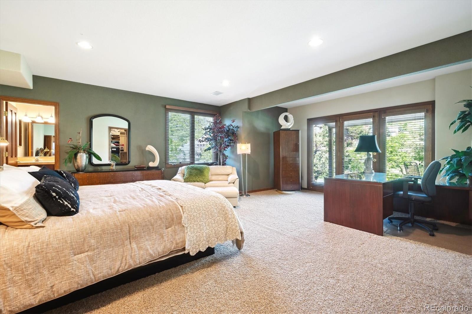 16134 Sandstone Drive Morrison, CO 80465 - Photo 21 of 30 a bedroom with a bed and glass window