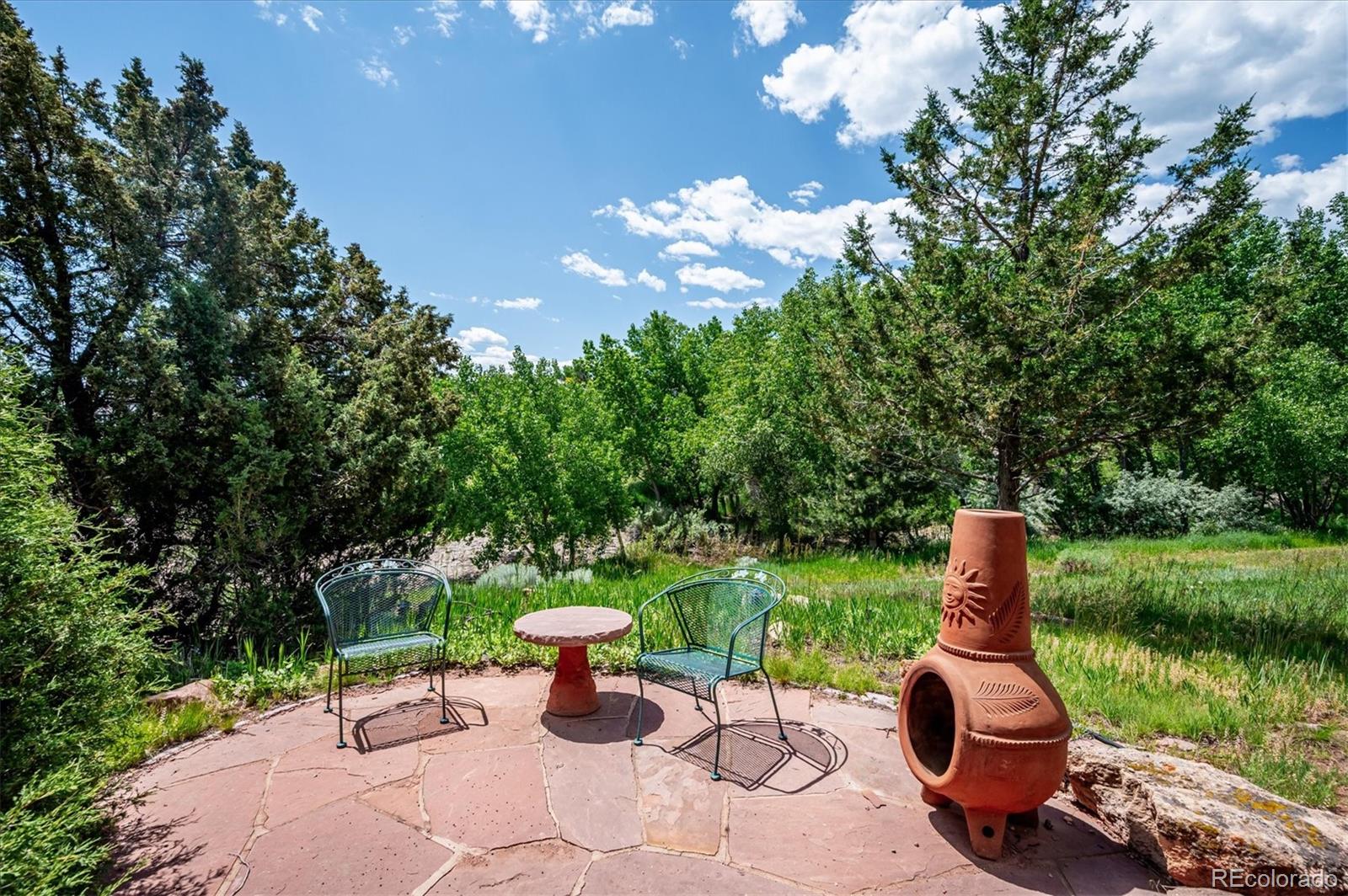16134 Sandstone Drive Morrison, CO 80465 - Photo 24 of 30 a view of a garden with an outdoor space and seating area