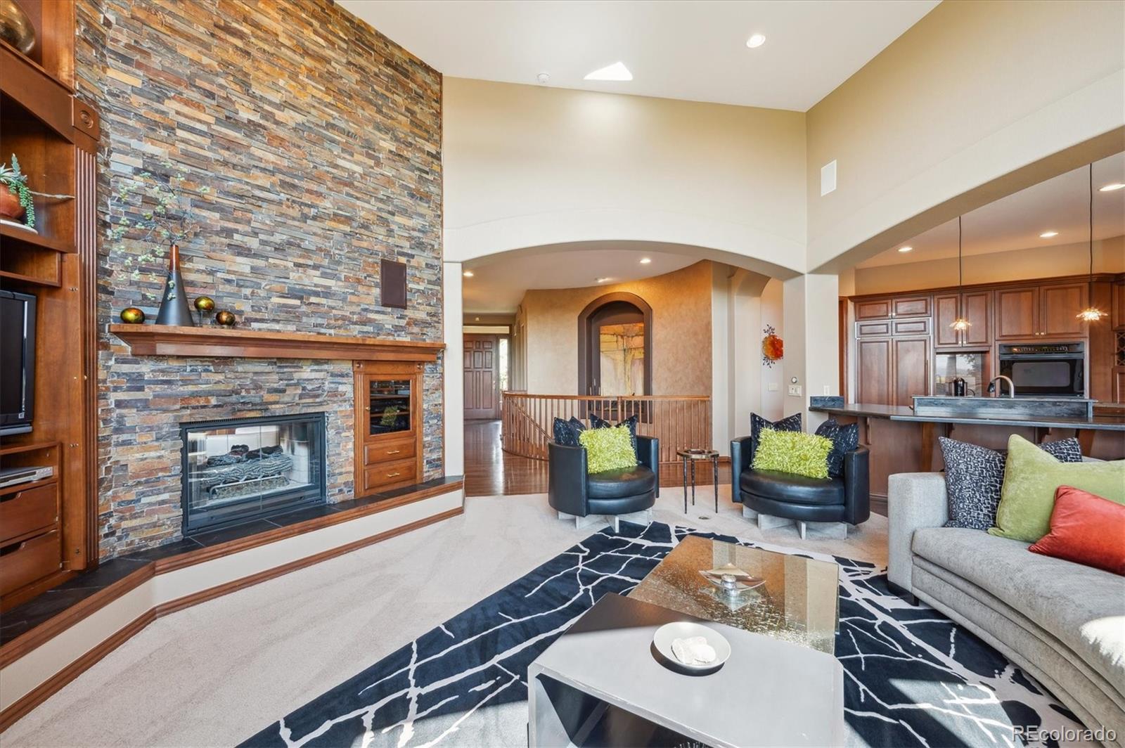 16134 Sandstone Drive Morrison, CO 80465 - Photo 5 of 30 a living room with furniture and a fireplace
