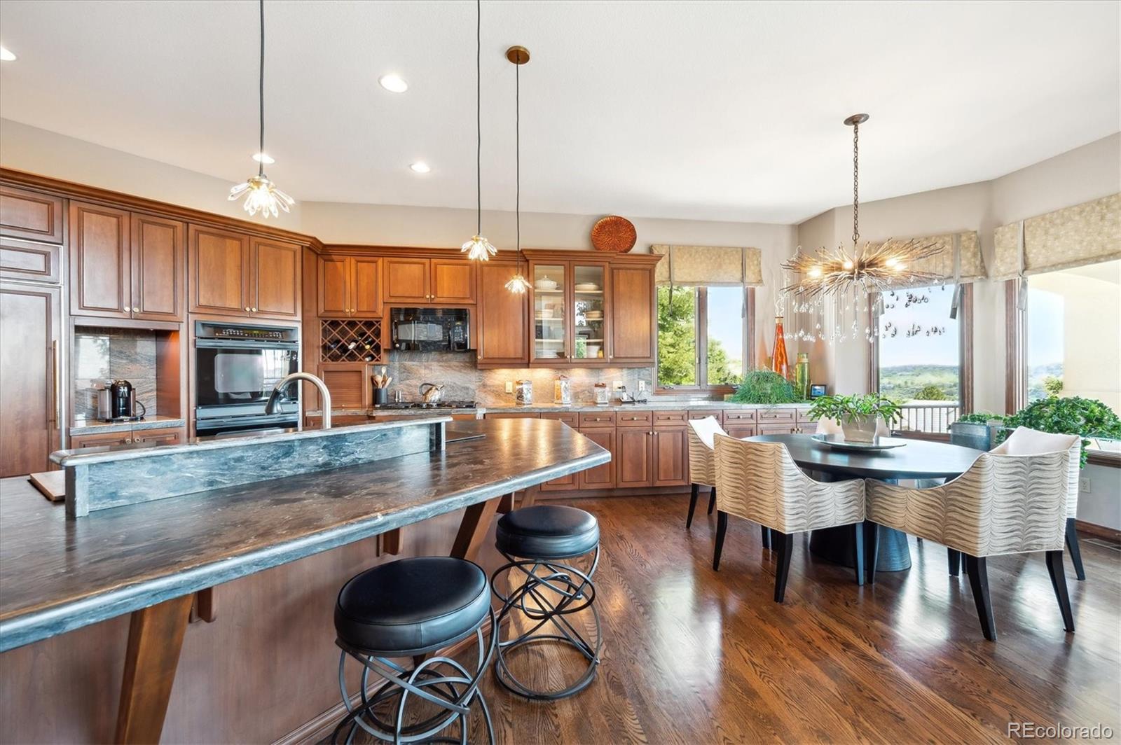 16134 Sandstone Drive Morrison, CO 80465 - Photo 6 of 30 a large kitchen with a table and chairs