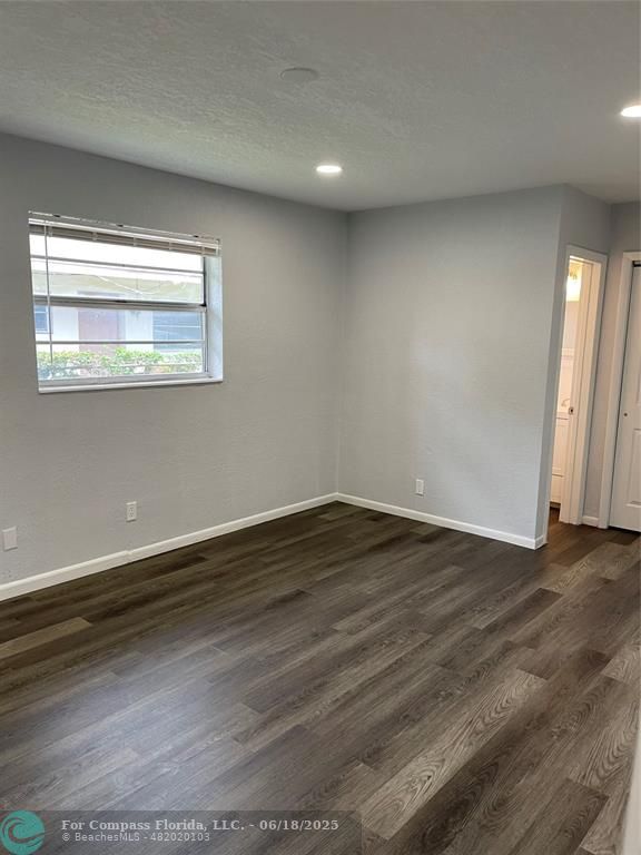 5631 Northwest 15th Street Lauderhill, FL 33313 - Photo 12 of 20 a view of an empty room with wooden floor and a window