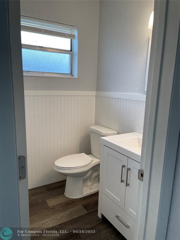 5631 Northwest 15th Street Lauderhill, FL 33313 - Photo 13 of 20 a white toilet sitting next to a bathroom sink