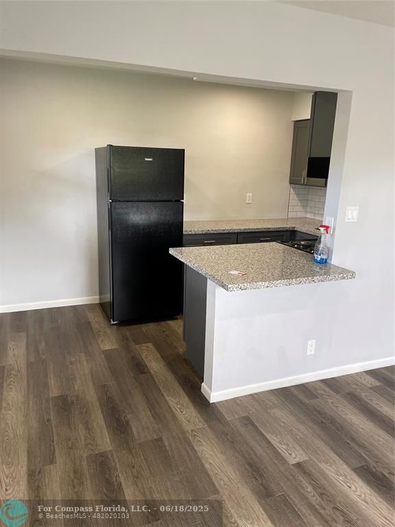 5631 Northwest 15th Street Lauderhill, FL 33313 - Photo 17 of 20 a kitchen with a sink and a refrigerator