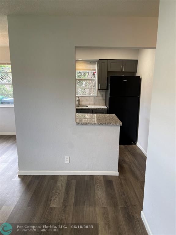 5631 Northwest 15th Street Lauderhill, FL 33313 - Photo 18 of 20 a view of kitchen with wooden floor and entryway
