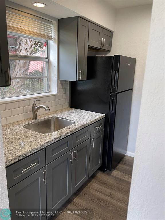 5631 Northwest 15th Street Lauderhill, FL 33313 - Photo 19 of 20 a kitchen with stainless steel appliances granite countertop a refrigerator and a sink
