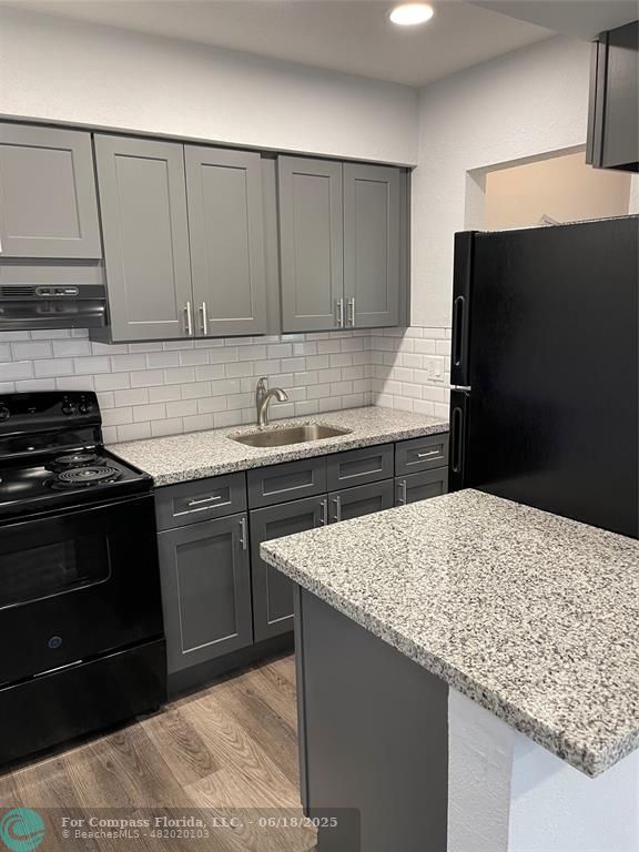 5631 Northwest 15th Street Lauderhill, FL 33313 - Photo 6 of 20 a kitchen with a sink and cabinets