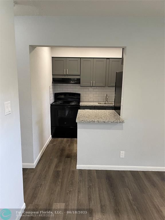 5631 Northwest 15th Street Lauderhill, FL 33313 - Photo 7 of 20 a kitchen with wooden floor and electronic appliances
