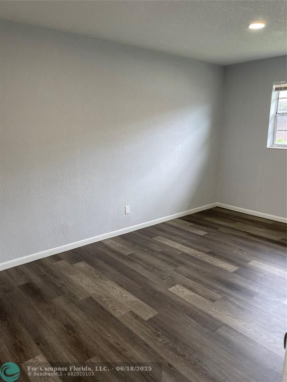 5631 Northwest 15th Street Lauderhill, FL 33313 - Photo 8 of 20 an empty room with wooden floor and windows