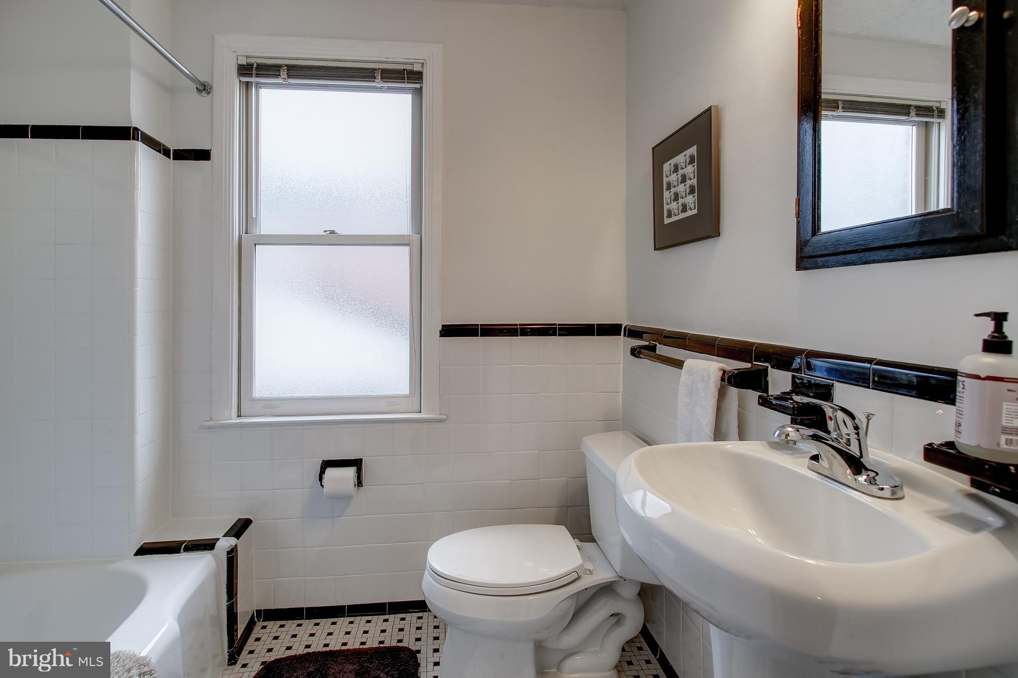 606 Ritchie Avenue Silver Spring, MD 20910 - Photo 14 of 27 a bathroom with a sink toilet and a mirror