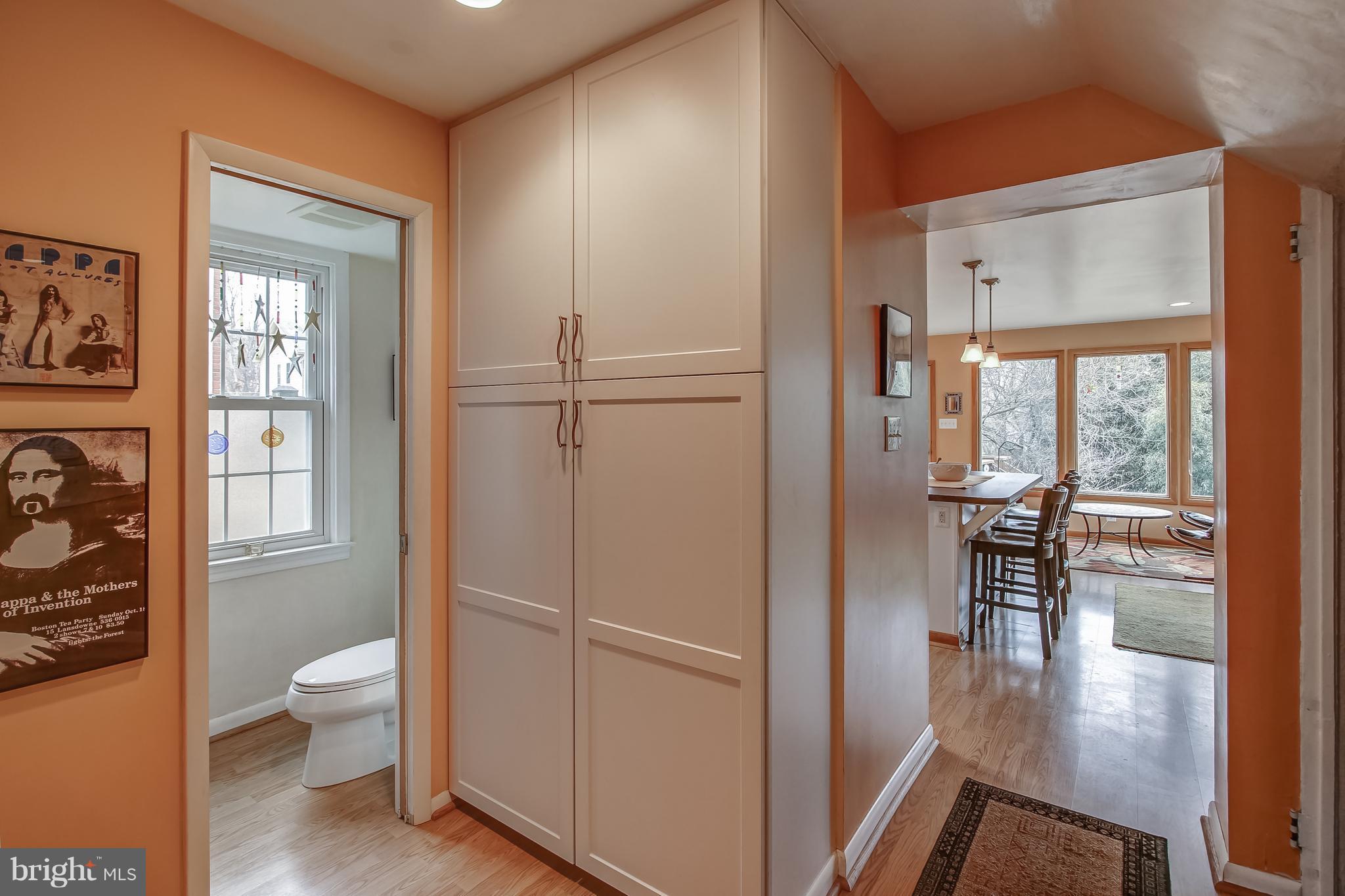 606 Ritchie Avenue Silver Spring, MD 20910 - Photo 8 of 27 a view of a hallway with wooden floor and a dining room