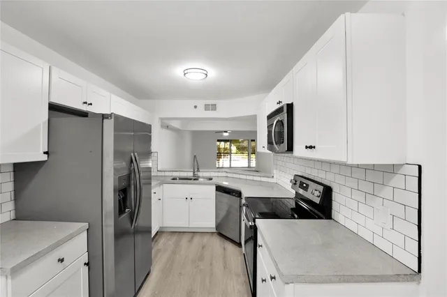 a kitchen with a refrigerator and a sink