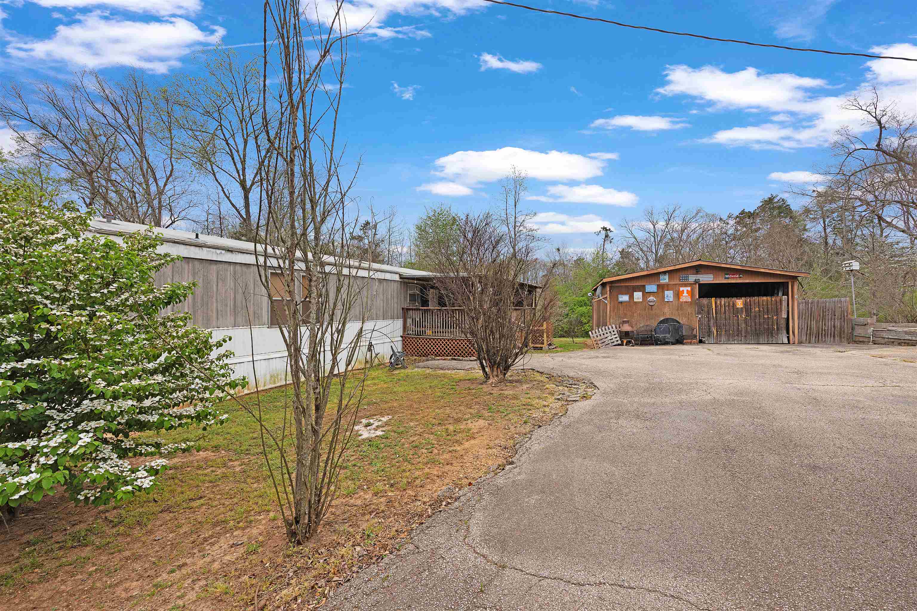 90 Rose Road Crump, TN 38327 - Photo 19 of 28 View of side of property with a wooden deck and driveway