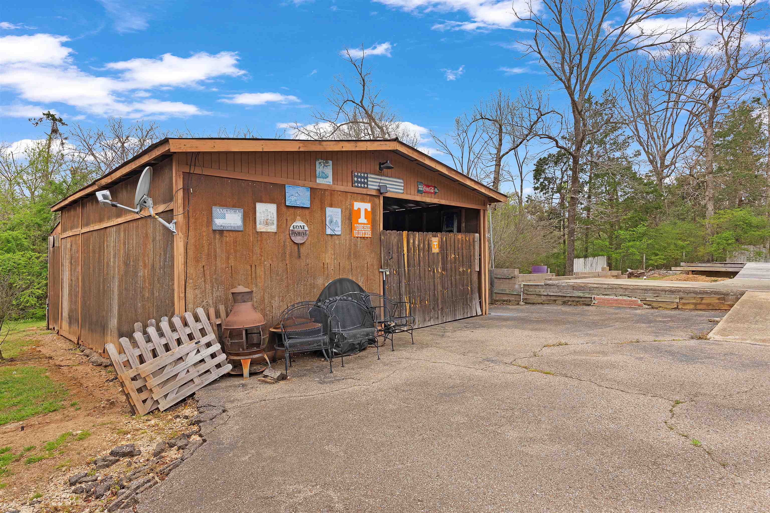 90 Rose Road Crump, TN 38327 - Photo 20 of 28 View of side of property with an outdoor structure and a patio area