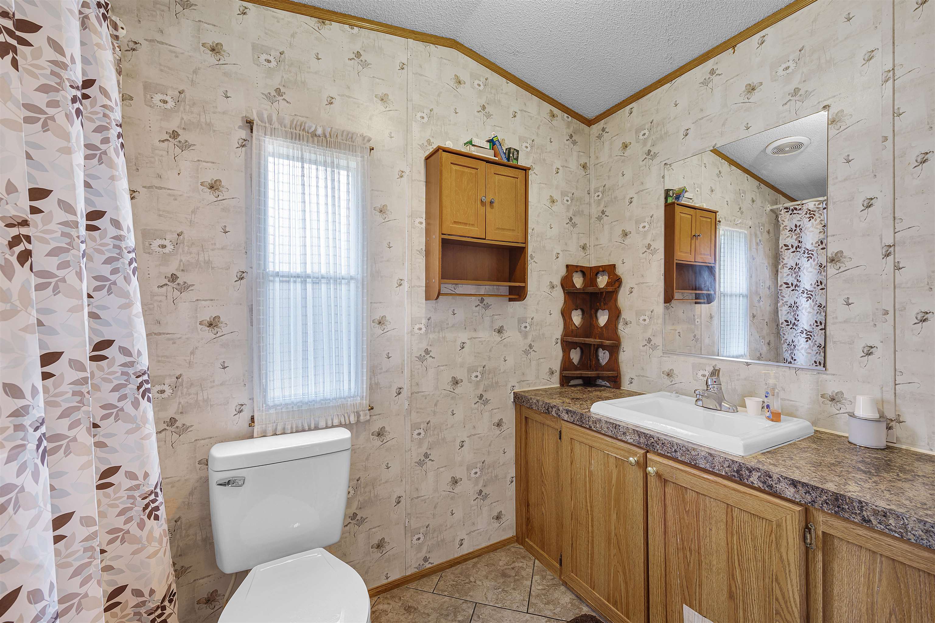 90 Rose Road Crump, TN 38327 - Photo 5 of 28 Bathroom with curtained shower, wallpapered walls, vanity, crown molding, and light tile patterned flooring