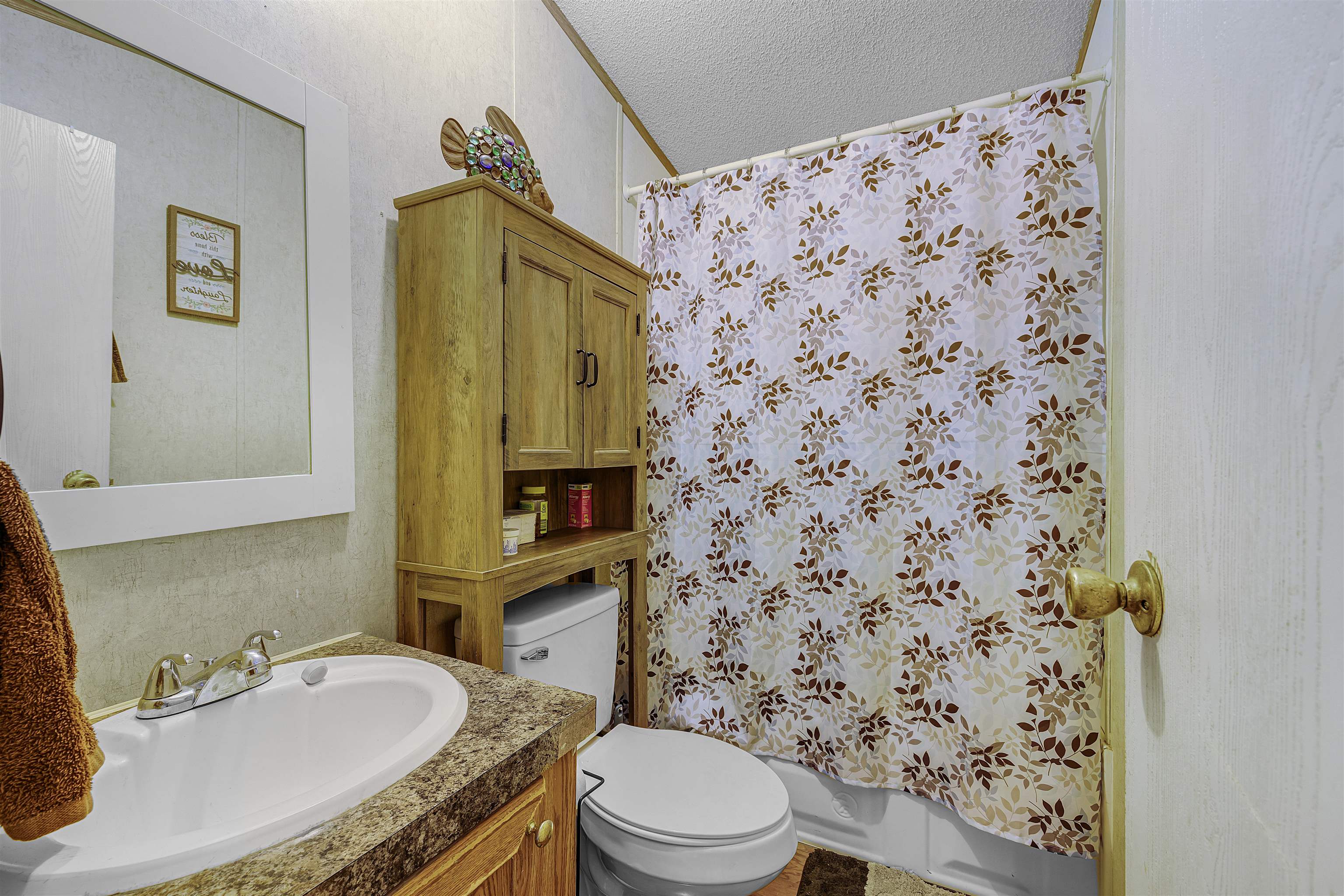 90 Rose Road Crump, TN 38327 - Photo 7 of 28 Full bath featuring vanity, a textured ceiling, shower / bath combo, and a textured wall