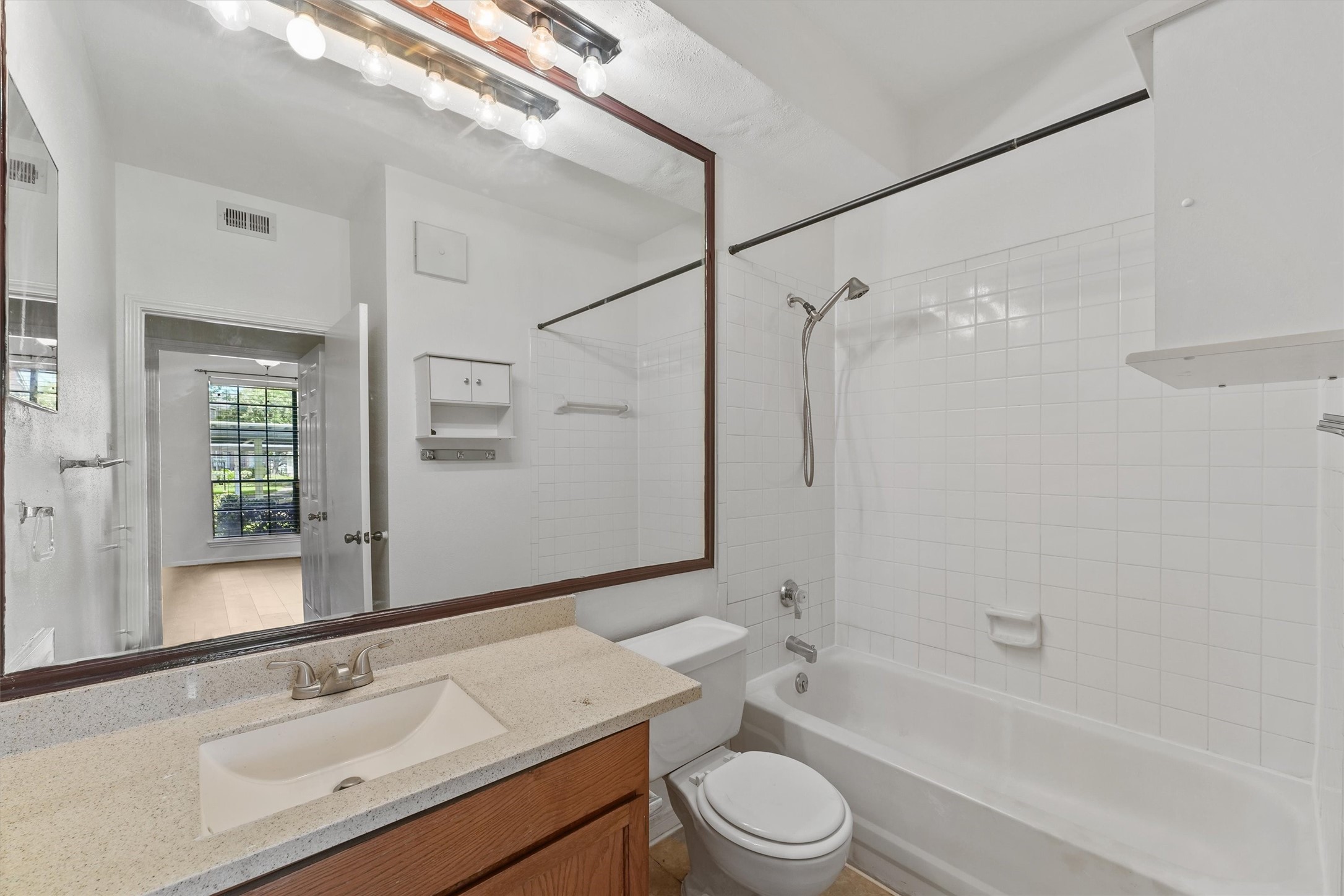 8055 Cambridge Street, Unit 21 Houston, TX 77054 - Photo 11 of 15 a bathroom with a sink granite toilet tub and shower