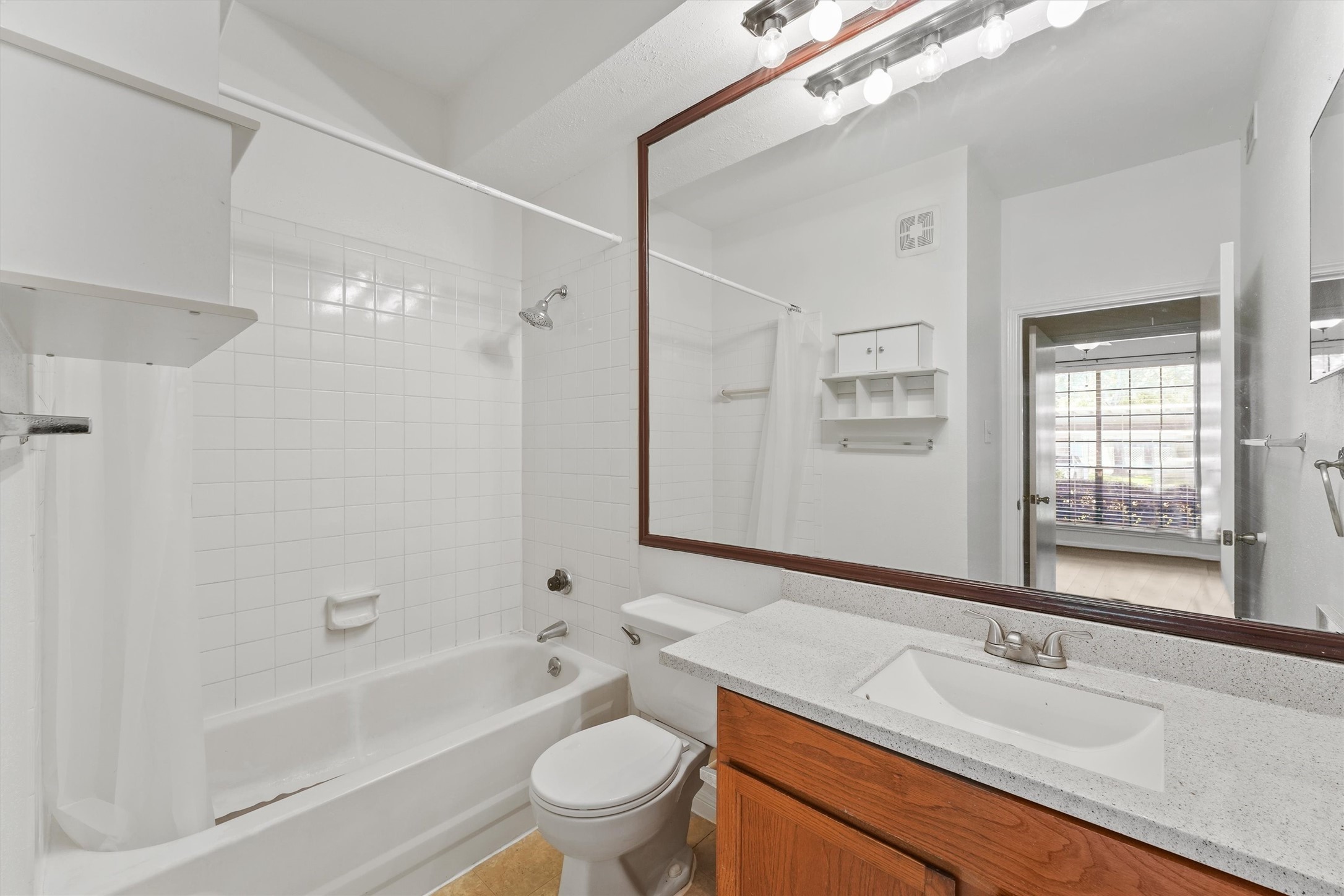 8055 Cambridge Street, Unit 21 Houston, TX 77054 - Photo 13 of 15 a bathroom with a sink a toilet and shower