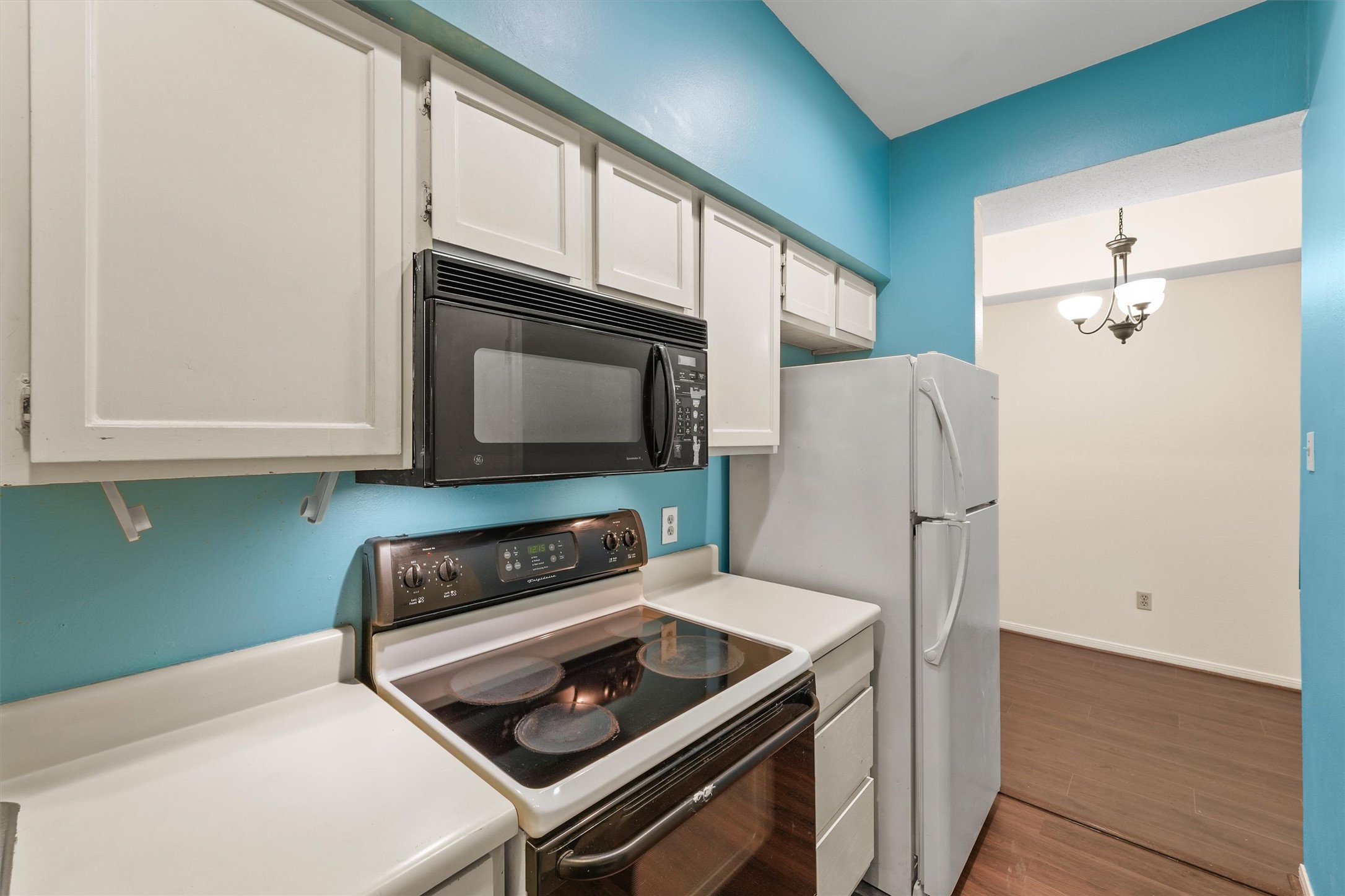 8055 Cambridge Street, Unit 21 Houston, TX 77054 - Photo 7 of 15 a kitchen with stainless steel appliances a stove a microwave and cabinets