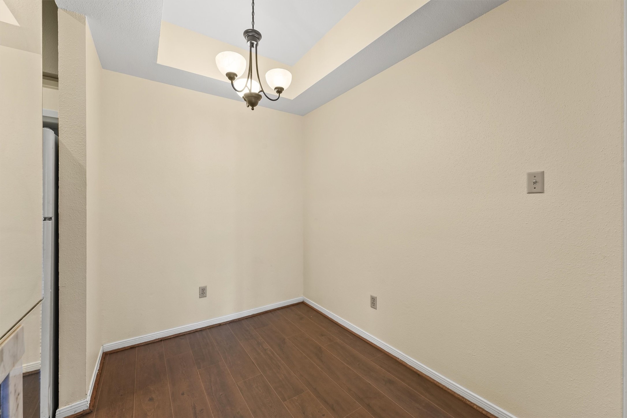 8055 Cambridge Street, Unit 21 Houston, TX 77054 - Photo 8 of 15 a view of a room with wooden floor and chandelier