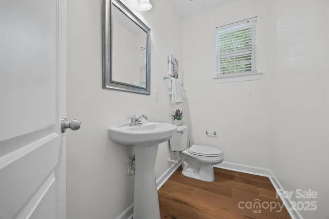 a bathroom with a sink toilet and a mirror
