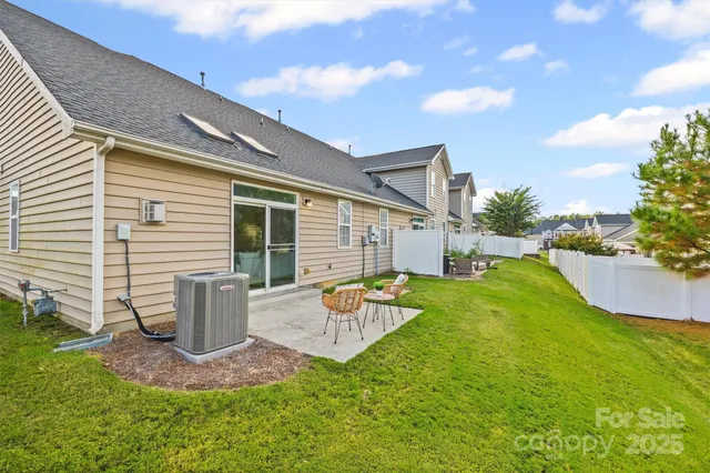 a backyard of a house with a garden and barbeque oven