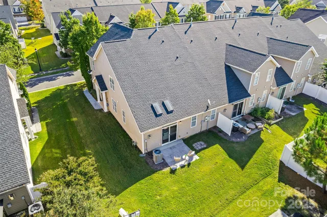 an aerial view of a house with garden space and street view